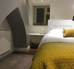 Bedroom with feature wall and double bed